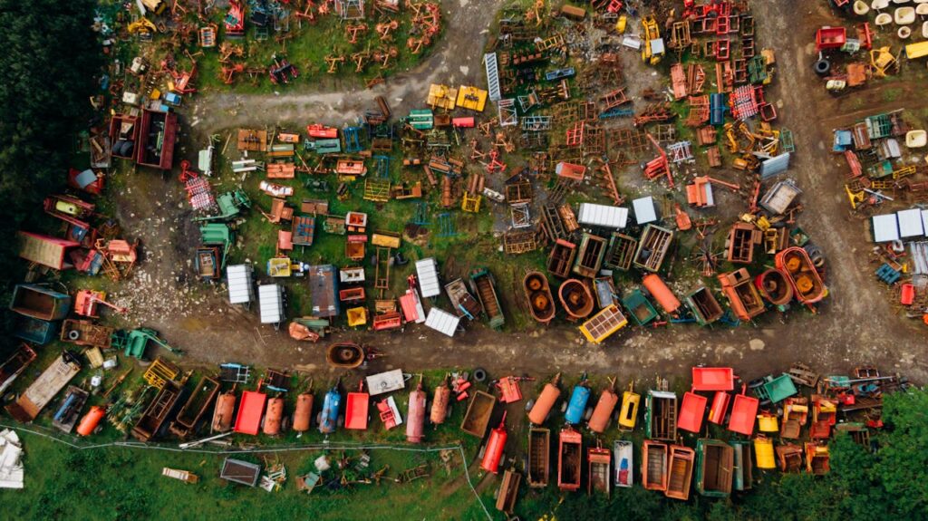 Vibrant aerial shot of a scrapyard filled with colorful metal items in Northern Ireland.